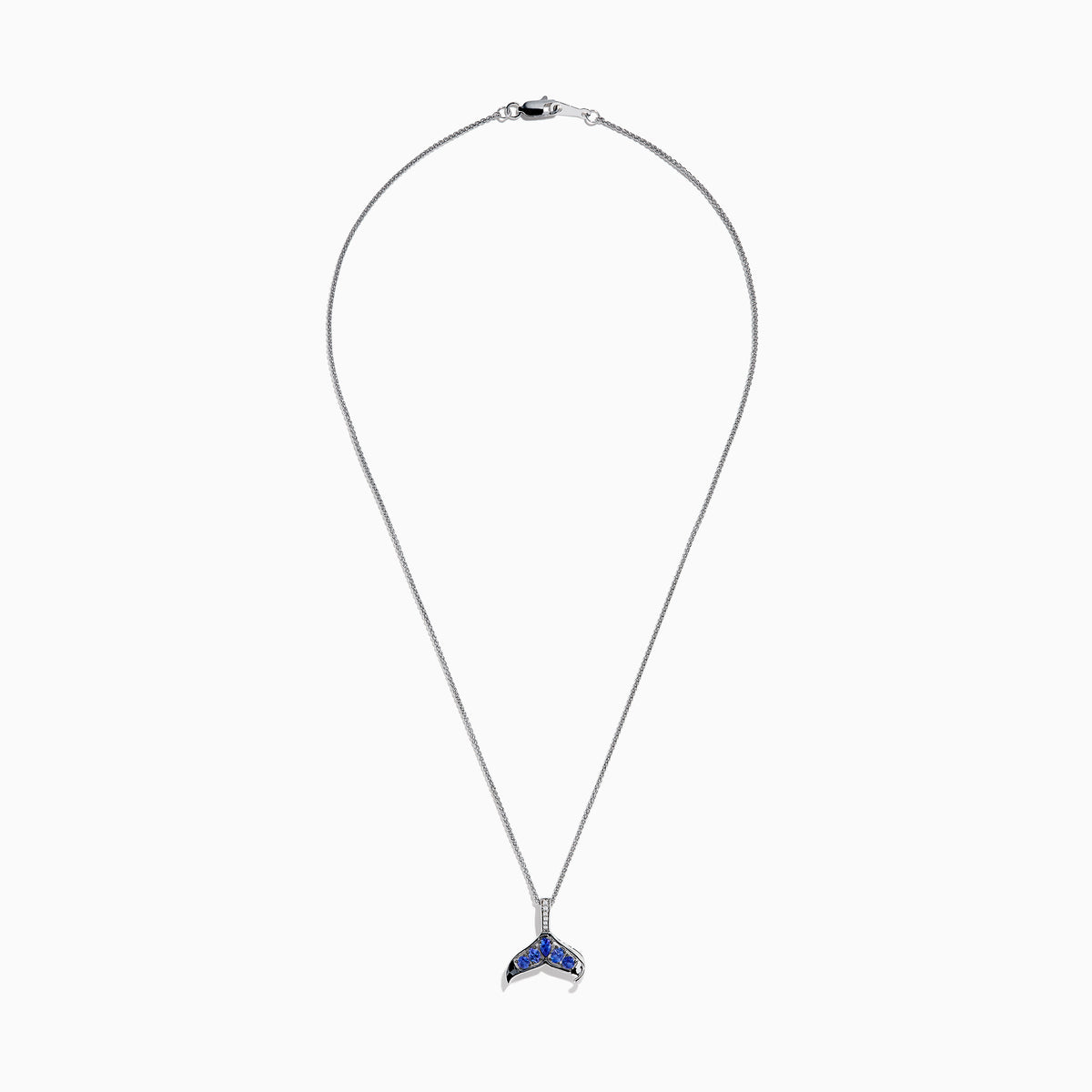 The 925 Silver Tanzanite and Diamond Whale Tail Pendant features a whale tail design with blue tanzanite gemstones and sparkling diamonds, crafted in 925 silver for a stunning shine against a white background.