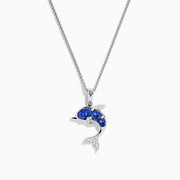 The 925 Silver Tanzanite and Diamond Dolphin Pendant features tanzanite-blue gems on the body and sparkling diamonds on the tail, elegantly showcased against a white background.