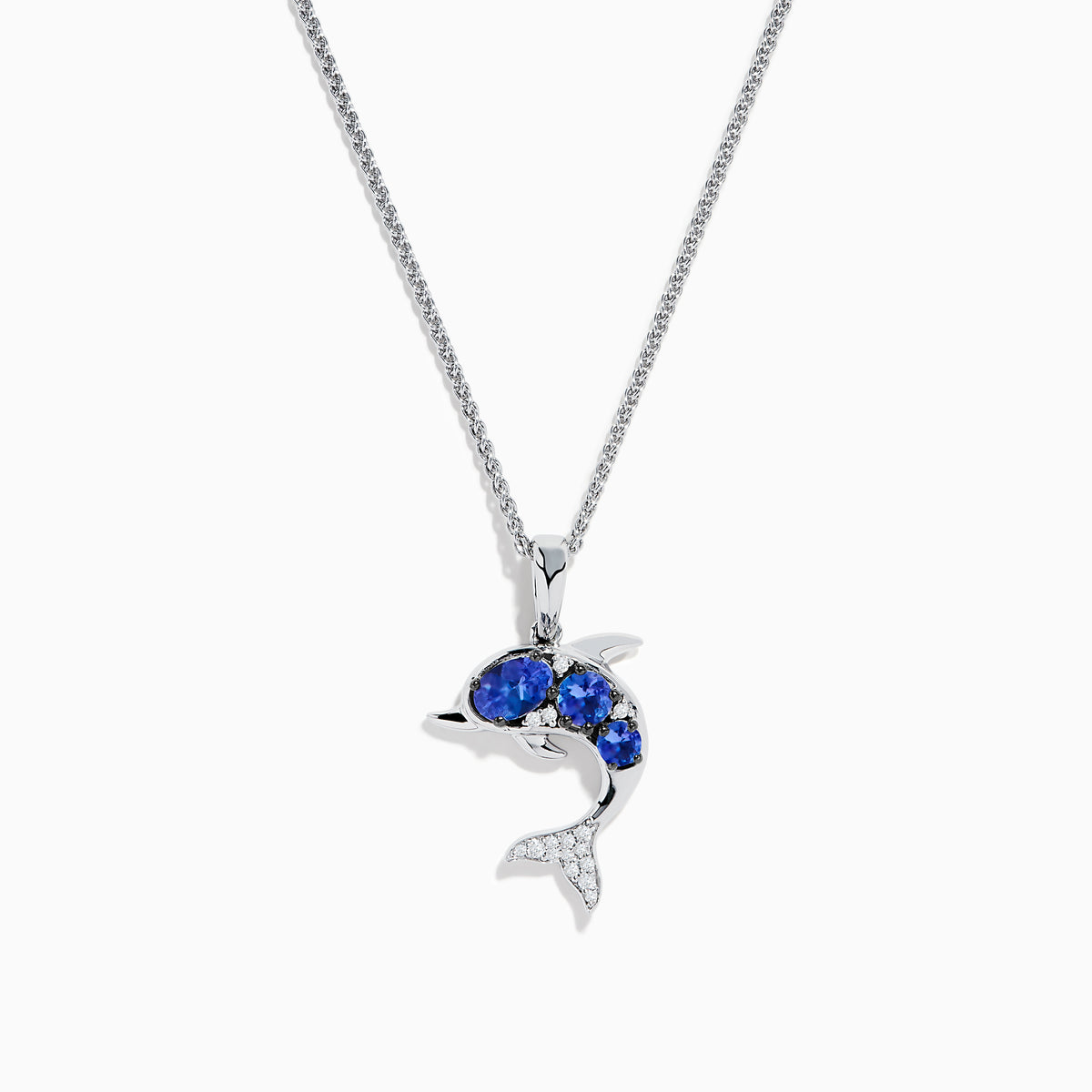 The 925 Silver Tanzanite and Diamond Dolphin Pendant features tanzanite-blue gems on the body and sparkling diamonds on the tail, elegantly showcased against a white background.
