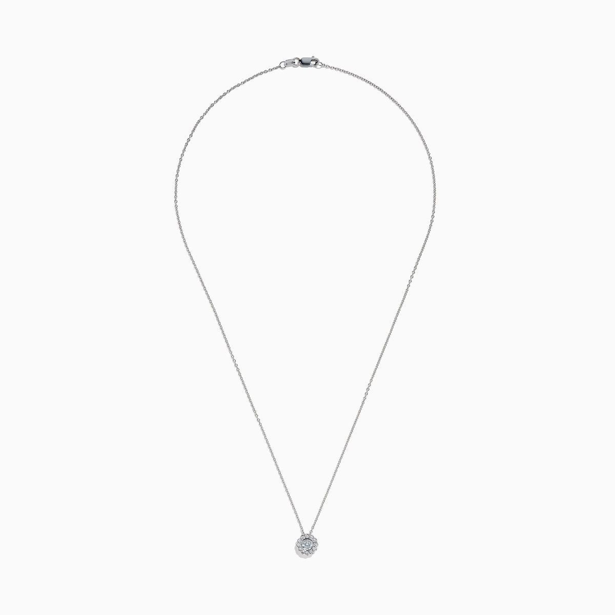 The 14K White Gold Diamond Bezel Halo Pendant features a delicate white gold chain with a round, flower-like diamond pendant, showcasing a central diamond surrounded by a halo of smaller diamonds.
