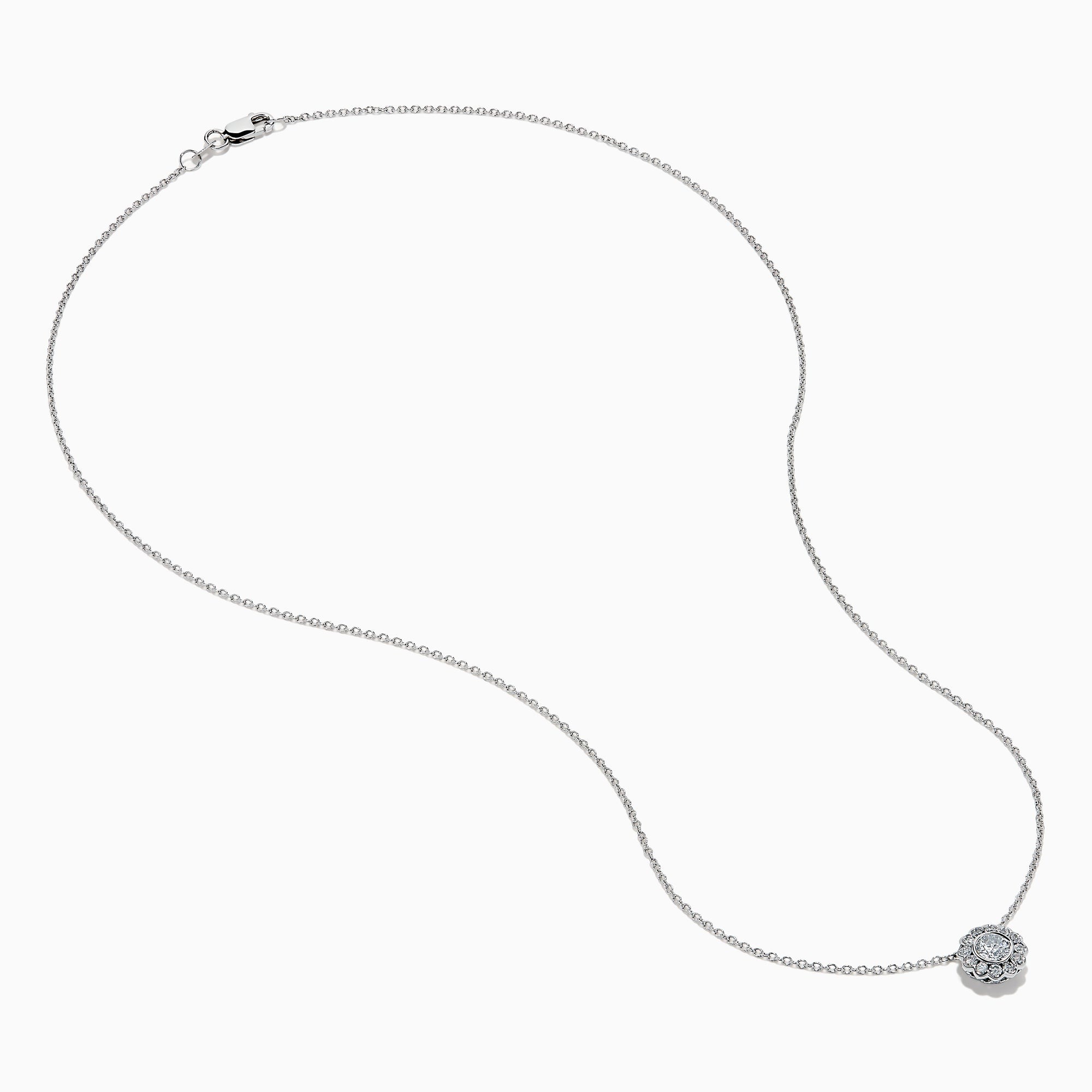 The 14K White Gold Diamond Bezel Halo Pendant features a delicate white gold chain with a round, flower-like diamond pendant, showcasing a central diamond surrounded by a halo of smaller diamonds.