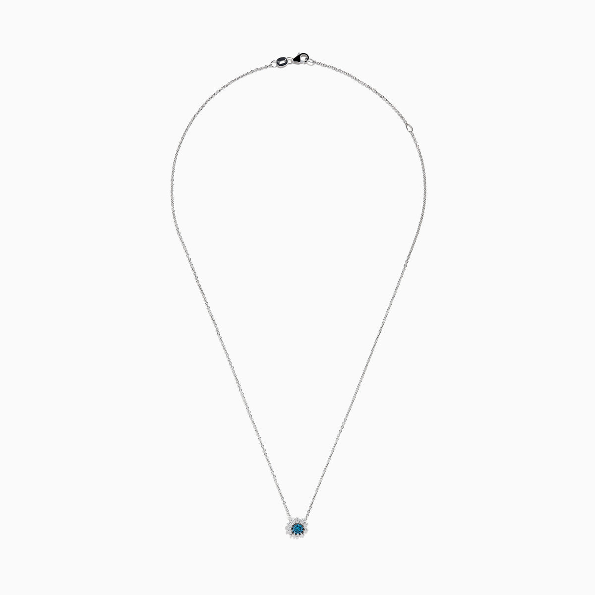The Bella Bleu 14K White Gold Pendant showcases a round blue and white diamond centerpiece, accented by a halo of 0.60 TCW diamonds, elegantly presented on a white background.