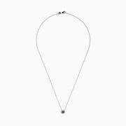 The Bella Bleu 14K White Gold Pendant showcases a round blue and white diamond centerpiece, accented by a halo of 0.60 TCW diamonds, elegantly presented on a white background.