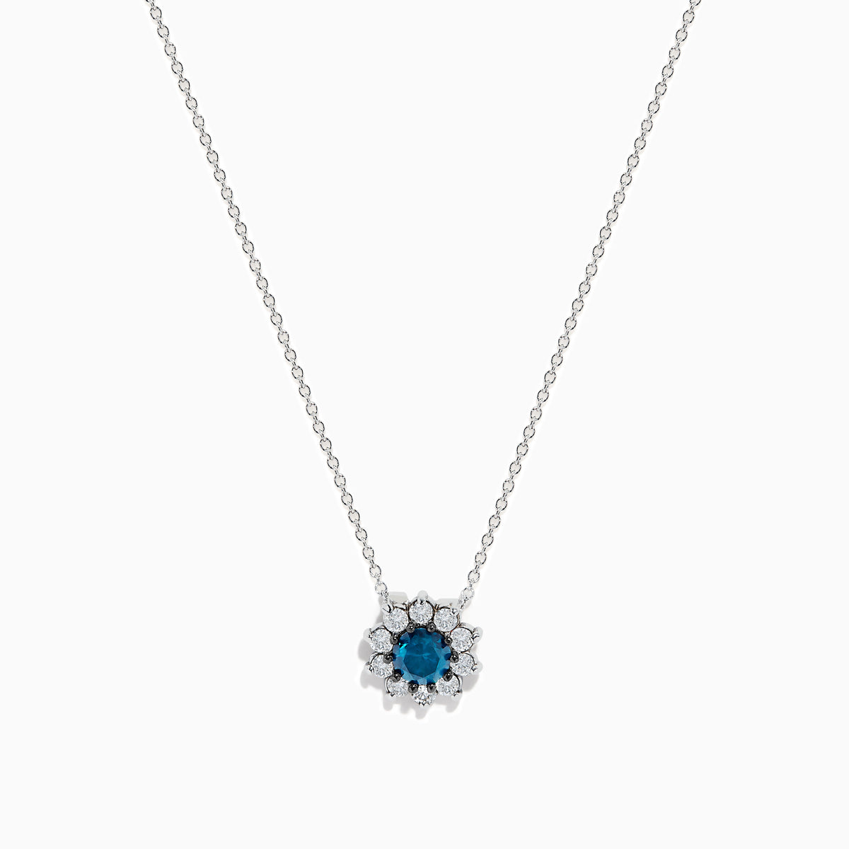 The Bella Bleu 14K White Gold Blue and White Diamond Pendant (1.60 TCW) features a flower-shaped design with a central blue stone and sparkling white diamonds, suspended on a fine chain against a plain white background.