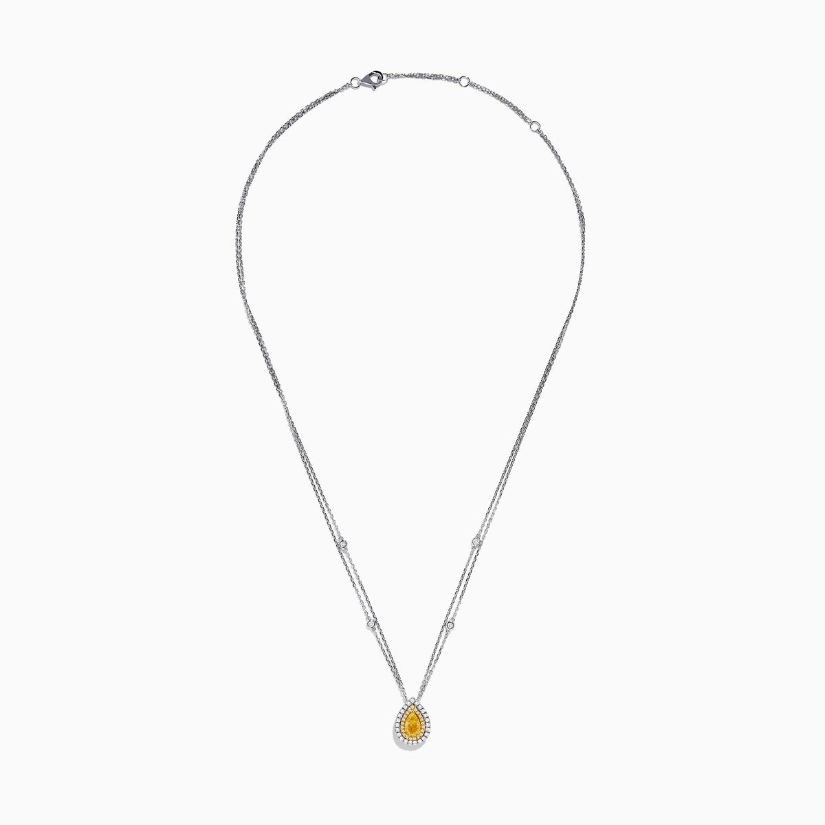 The 18K Two Toned White & Yellow Diamond Layered Doble Halo Pendant features a double-strand silver necklace with a pear-shaped yellow gemstone, diamond halos, and additional round diamonds on layered chains.