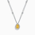 The 18K Two Toned White & Yellow Diamond Layered Doble Halo Pendant features a double-strand silver necklace with a pear-shaped yellow gemstone, diamond halos, and additional round diamonds on layered chains.