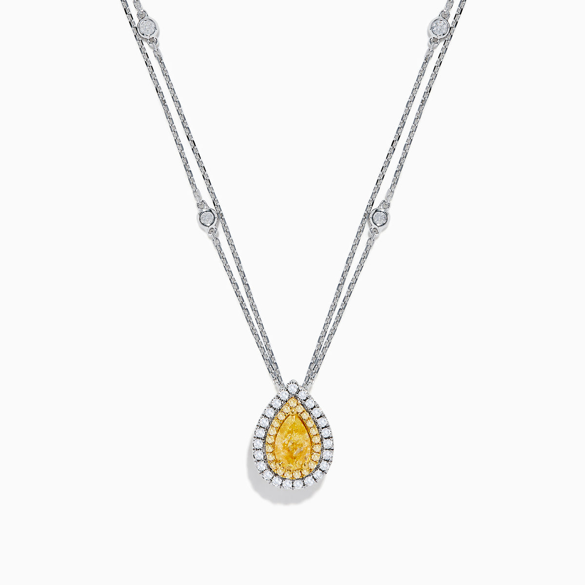 The 18K Two Toned White & Yellow Diamond Layered Doble Halo Pendant features a double-strand silver necklace with a pear-shaped yellow gemstone, diamond halos, and additional round diamonds on layered chains.