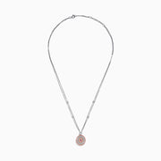 The 18K Two Tone Gold White and Pink Diamond Pendant necklace features a double-chain design with a round pendant of concentric circles, set with white and pink diamonds and topped by a single white gemstone.