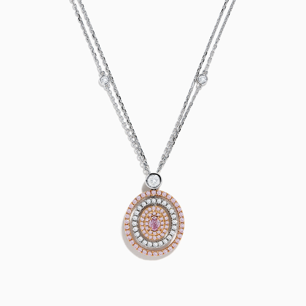 The 18K Two Tone Gold White and Pink Diamond Pendant necklace features a double-chain design with a round pendant of concentric circles, set with white and pink diamonds and topped by a single white gemstone.