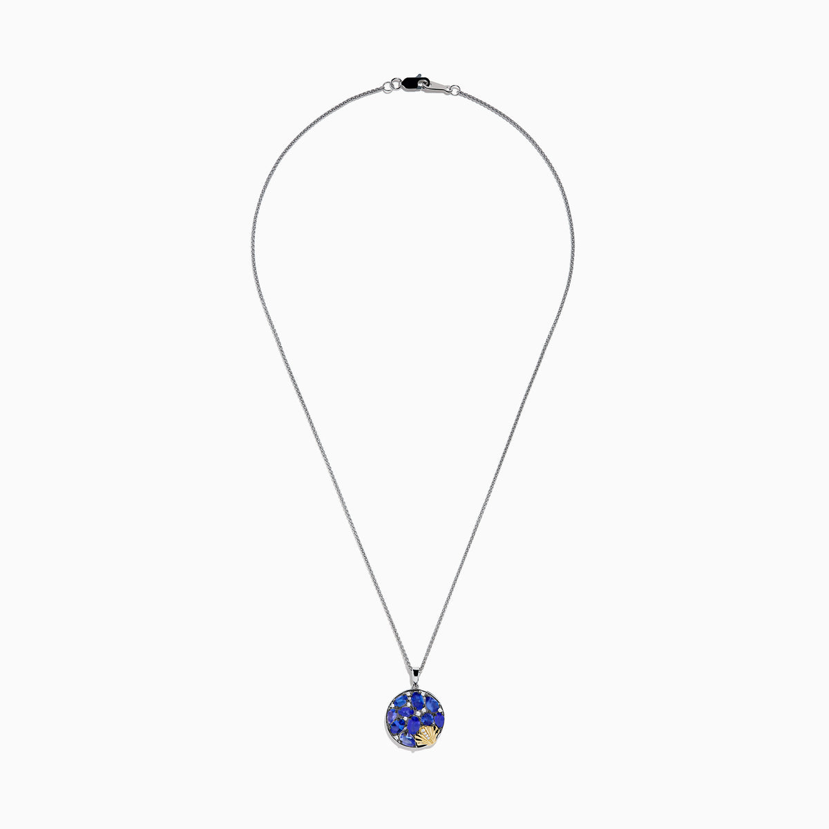 The Nahla 925 Silver and 18K Yellow Gold Tanzanite and Diamond Seashell Pendant features clustered tanzanite gems in a round design, accented with a small diamond 18K yellow gold seashell at the bottom right.