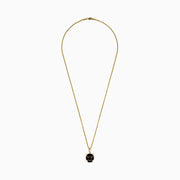 The Mens 14K Yellow Gold Onyx Panther Pendant features a geometric black and gold design, elegantly displayed on a yellow gold chain against a white background.