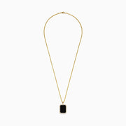 The Mens 14K Yellow Gold Black Onyx and Diamond Pendant features a rectangular black onyx bordered by diamonds, hanging from a delicate gold chain against a white background.