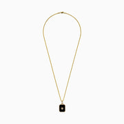 A 14K yellow gold agate and diamond pendant necklace with a rectangular black agate, gold starburst design, and a small central diamond, shown on a plain white background.