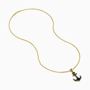 The Men's 14K Yellow Gold Black Diamond Anchor Pendant features a yellow gold chain and an anchor-shaped pendant adorned with small black diamonds, geometric details at the top, and pointed arrow-like ends.