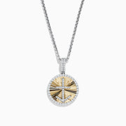This Novelty 14K white and yellow gold coin pendant features a diamond anchor at the center of a gold sunburst design, all set on a silver chain and surrounded by a border of sparkling diamonds.