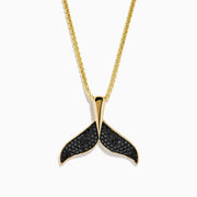 The Men's 14K Yellow Gold Black Diamond Whales Tail Pendant features black diamonds on each fin and hangs from a delicate chain, shown against a plain white background.
