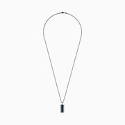 The Men's 14K White Gold White and Blue Diamond Dog Tag Pendant features a silver tag with a vertical row of blue diamonds bordered by clear gemstones, crafted in polished 14K white gold.