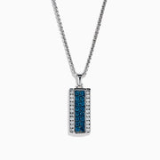 The Men's 14K White Gold White and Blue Diamond Dog Tag Pendant features a silver tag with a vertical row of blue diamonds bordered by clear gemstones, crafted in polished 14K white gold.