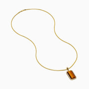 Men's 14K yellow gold dog tag pendant featuring a polished tiger eye center, accented with sparkling diamonds and a gleaming gold border.