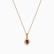 The 14K Rose Gold Brown and White Diamond Halo Pendant features an oval brown and white diamond surrounded by small clear stones in a decorative setting.