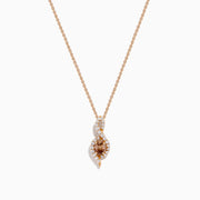 The Espresso 14K Rose Gold Brown and White Diamond Pendant features an oval brown gemstone surrounded by white diamonds in a swirling design, gracefully hanging from a delicate rose gold chain.