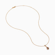 The 14K Rose Gold Pear Halo Brown and White Diamond Pendant features a teardrop-shaped brown and white diamond centerpiece, bordered with sparkling clear stones and accented by a vertical row of clear stones above.