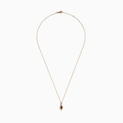 The 14K Rose Gold Brown and White Diamond Pendant features a marquise-shaped brown gemstone at its center, highlighted by a twisting design set with sparkling brown and white diamonds.