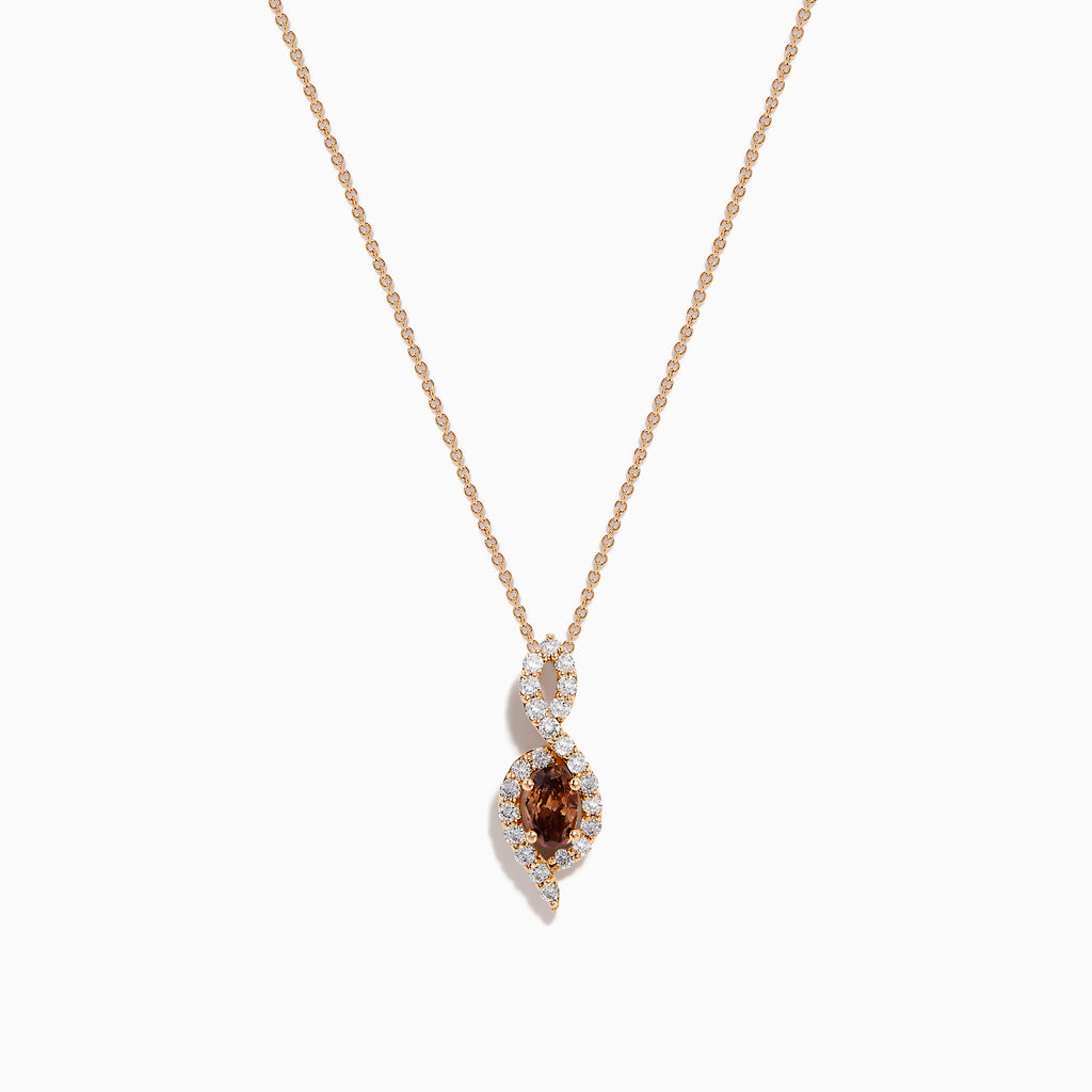 The 14K Rose Gold Brown and White Diamond Pendant features a marquise-shaped brown gemstone at its center, highlighted by a twisting design set with sparkling brown and white diamonds.
