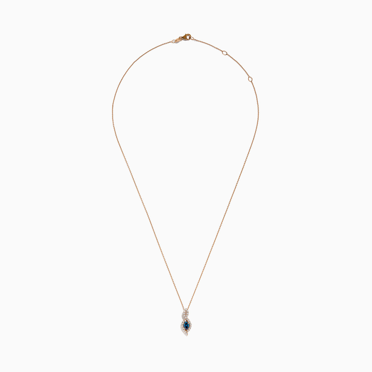 The 14K Rose Gold Blue and White Diamond Pendant features a deep blue oval gemstone with sparkling blue and white diamonds set in a twisting, teardrop-shaped design.