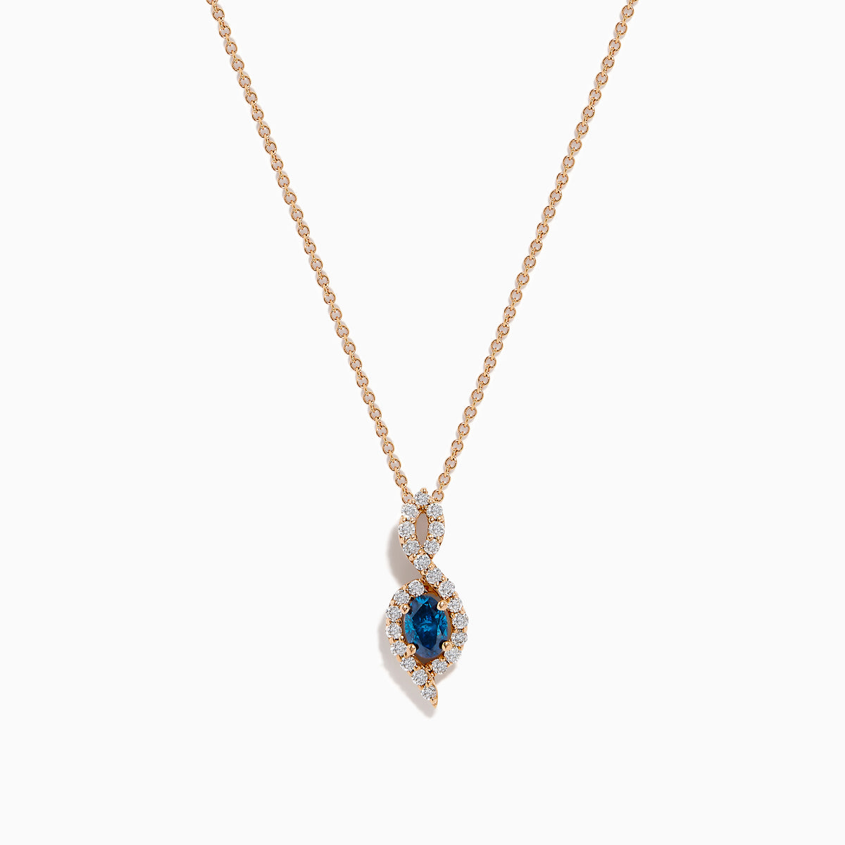 The 14K Rose Gold Blue and White Diamond Pendant features a deep blue oval gemstone with sparkling blue and white diamonds set in a twisting, teardrop-shaped design.