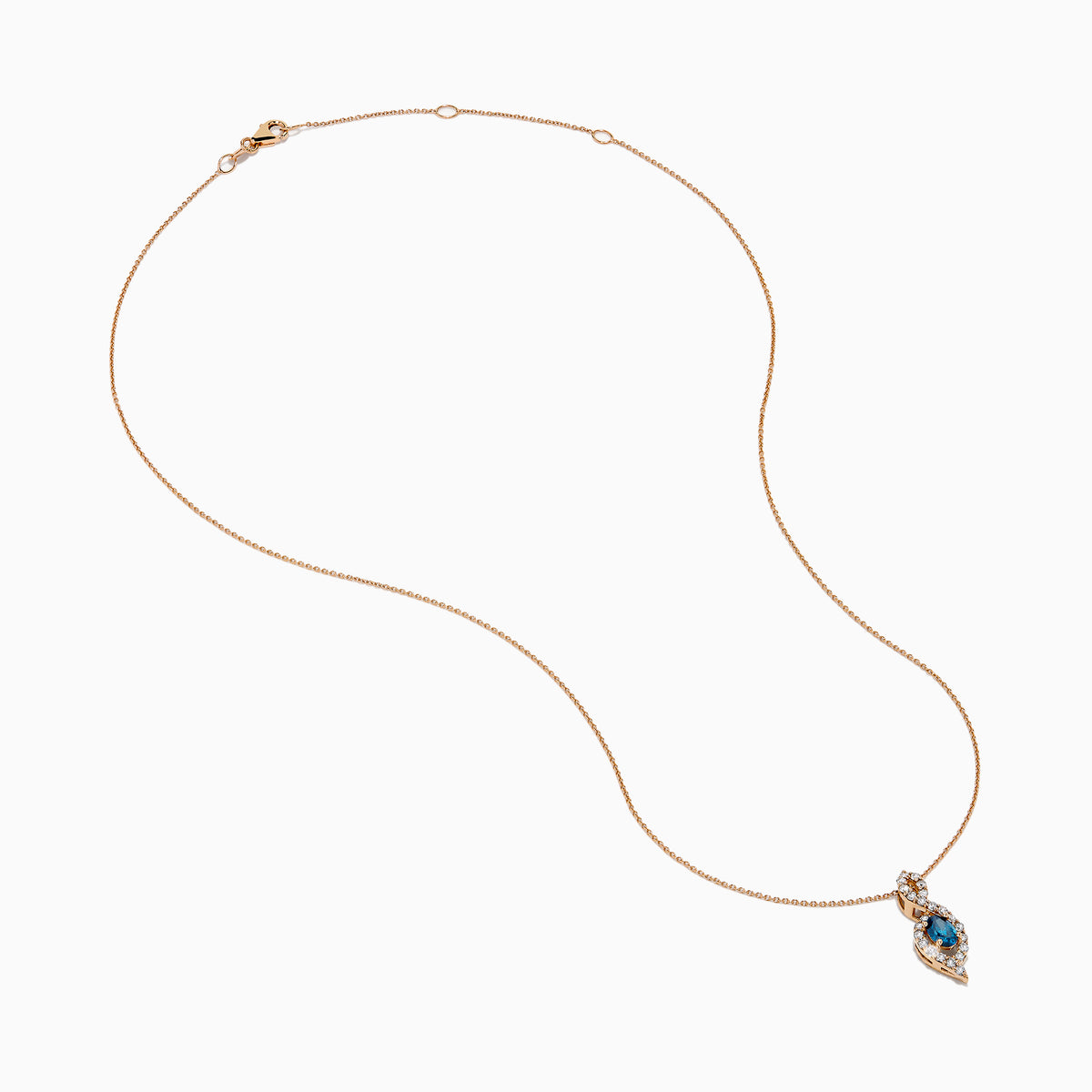 The 14K Rose Gold Blue and White Diamond Pendant features a deep blue oval gemstone with sparkling blue and white diamonds set in a twisting, teardrop-shaped design.
