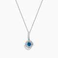 The Bella Bleu 14K White Gold Blue and White Diamond Pendant features a central blue diamond surrounded by a halo of white diamonds, displayed against a plain white background.