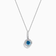 The Bella Bleu 14K White Gold Blue and White Diamond Pendant features a central blue diamond surrounded by a halo of white diamonds, displayed against a plain white background.