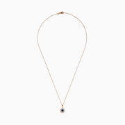 The Bella Bleu 14K Rose Gold Blue and White Diamond Pendant features a round dark blue gemstone center, encircled by sparkling white diamonds, all on a rose gold chain and shown against a white background.