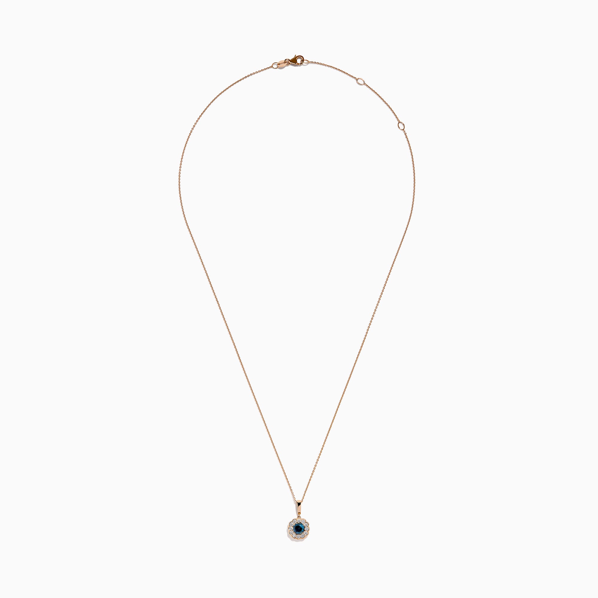 The Bella Bleu 14K Rose Gold Blue and White Diamond Pendant features a round dark blue gemstone center, encircled by sparkling white diamonds, all on a rose gold chain and shown against a white background.