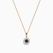 The Bella Bleu 14K Rose Gold Blue and White Diamond Pendant features a round dark blue gemstone center, encircled by sparkling white diamonds, all on a rose gold chain and shown against a white background.