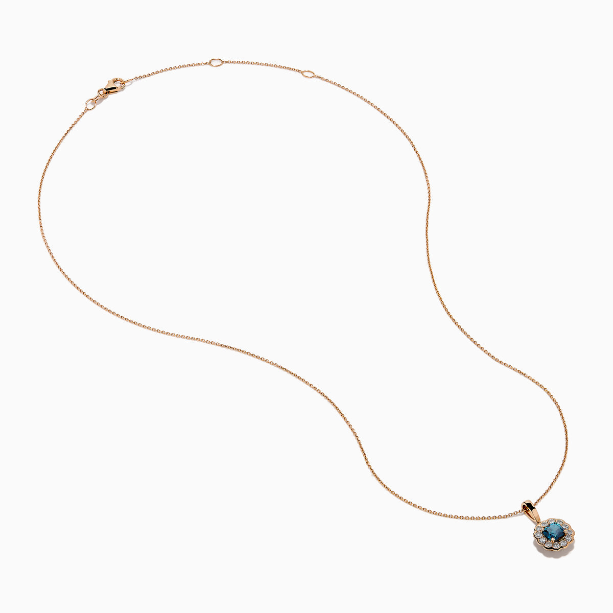 The Bella Bleu 14K Rose Gold Blue and White Diamond Pendant features a round dark blue gemstone center, encircled by sparkling white diamonds, all on a rose gold chain and shown against a white background.