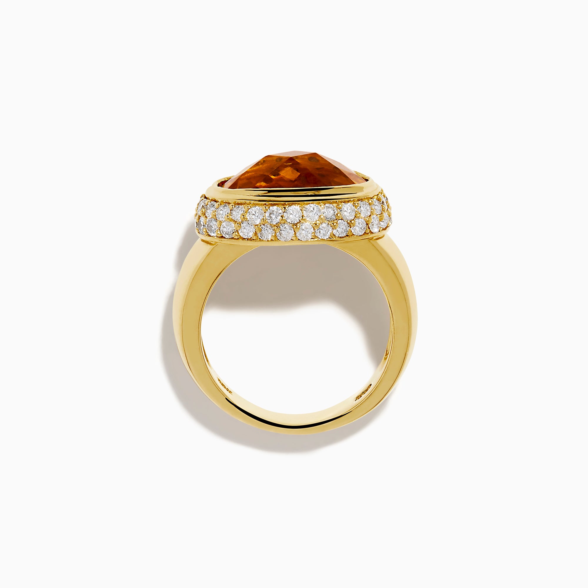 An 18K yellow gold ring featuring an east-west set oval citrine centerpiece, accented by a bezel halo of sparkling diamonds.