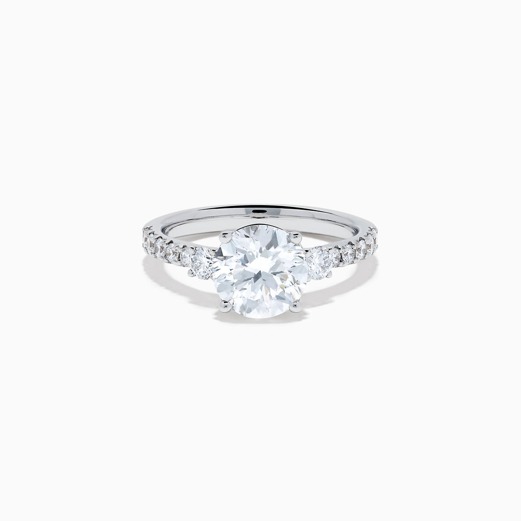 The Star Lab Grown Diamond Ring in 18K White Gold showcases a large round-cut lab diamond center with smaller diamonds along the band, beautifully displayed on a white background.
