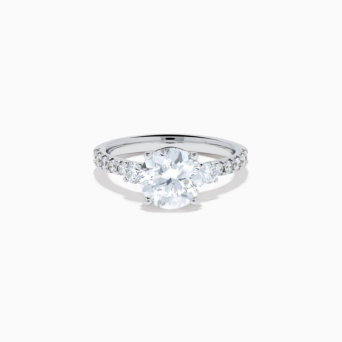 The Star Lab Grown Diamond Ring in 18K White Gold showcases a large round-cut lab diamond center with smaller diamonds along the band, beautifully displayed on a white background.