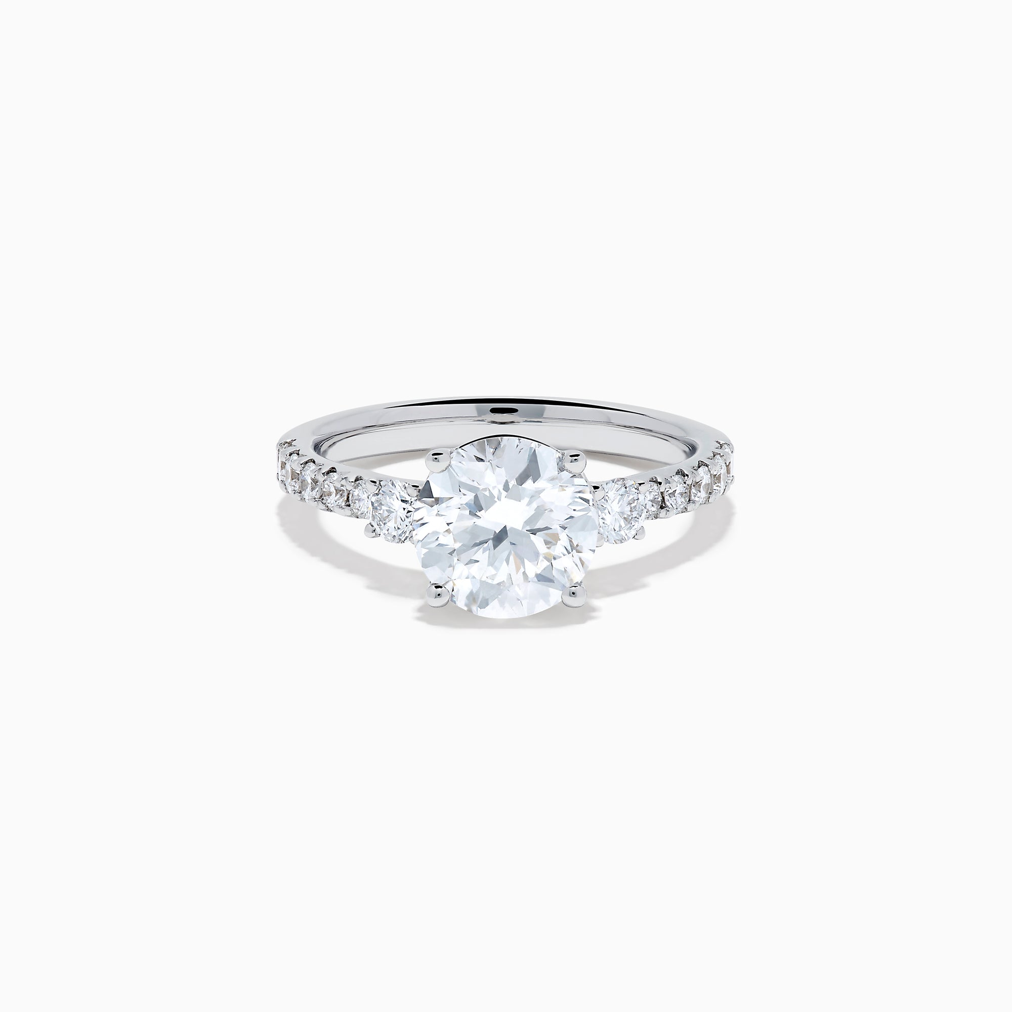 The Star Lab Grown Diamond Ring in 18K White Gold showcases a large round-cut lab diamond center with smaller diamonds along the band, beautifully displayed on a white background.