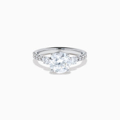 The Star Lab Grown Diamond Ring in 18K White Gold showcases a large round-cut lab diamond center with smaller diamonds along the band, beautifully displayed on a white background.