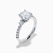The Star Lab Grown Diamond Ring in 18K White Gold showcases a large round-cut lab diamond center with smaller diamonds along the band, beautifully displayed on a white background.