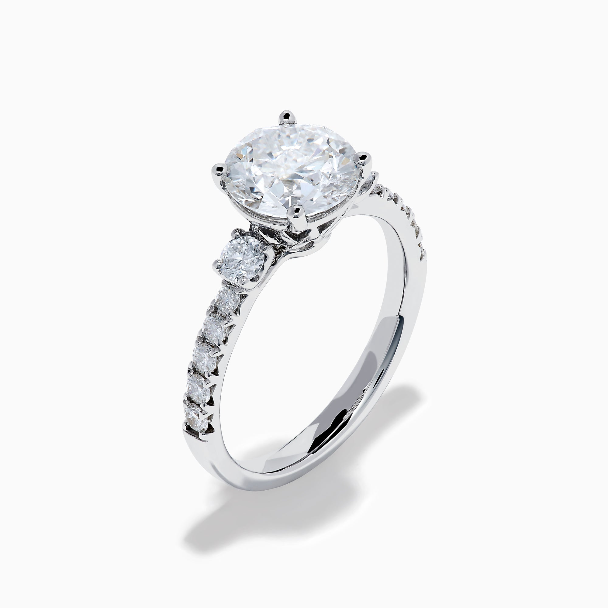 The Star Lab Grown Diamond Ring in 18K White Gold showcases a large round-cut lab diamond center with smaller diamonds along the band, beautifully displayed on a white background.