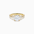 The Star Lab Grown Diamond Ring in 18K yellow gold features a large round center stone with smaller diamonds along the band, shown against a white background.