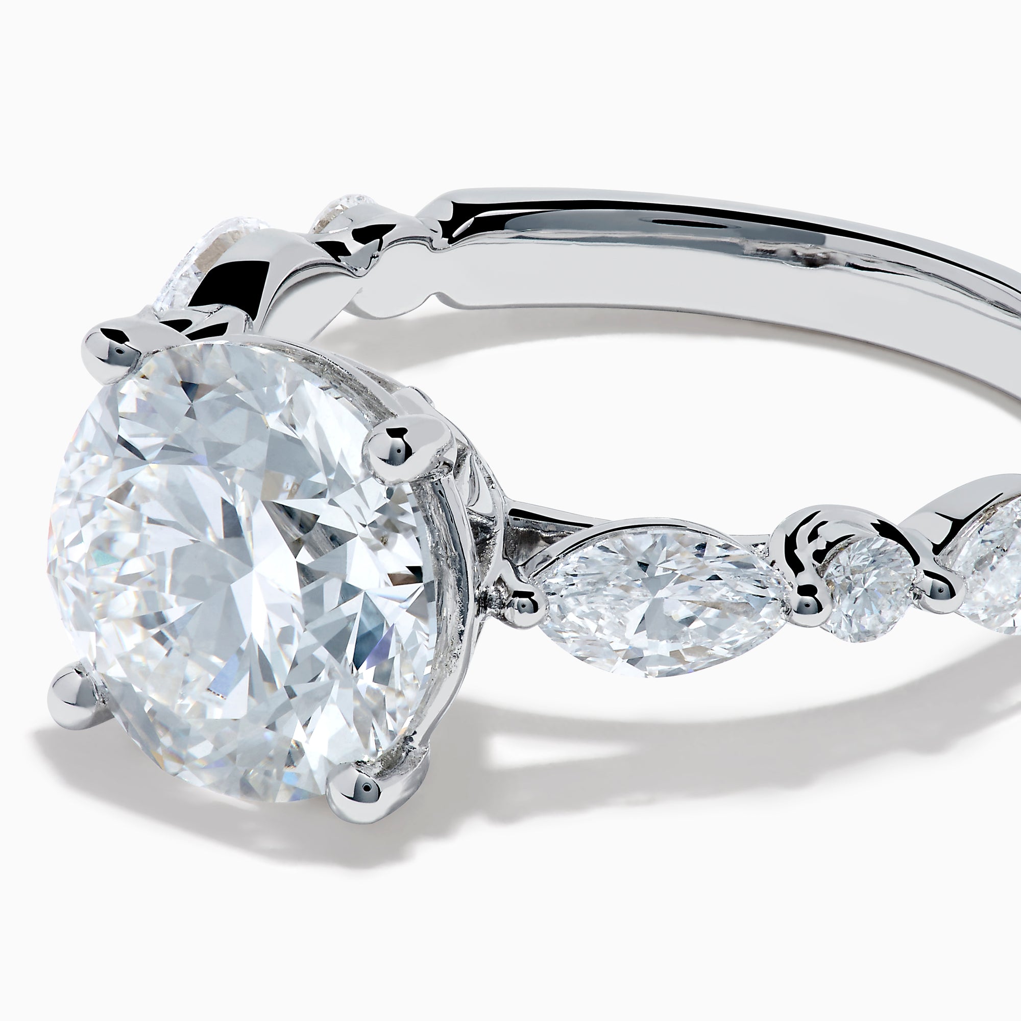 The Star Lab Grown Diamond Ring in 18K White Gold features a large oval lab diamond center with two round diamonds on each side, beautifully set and displayed on a white background.