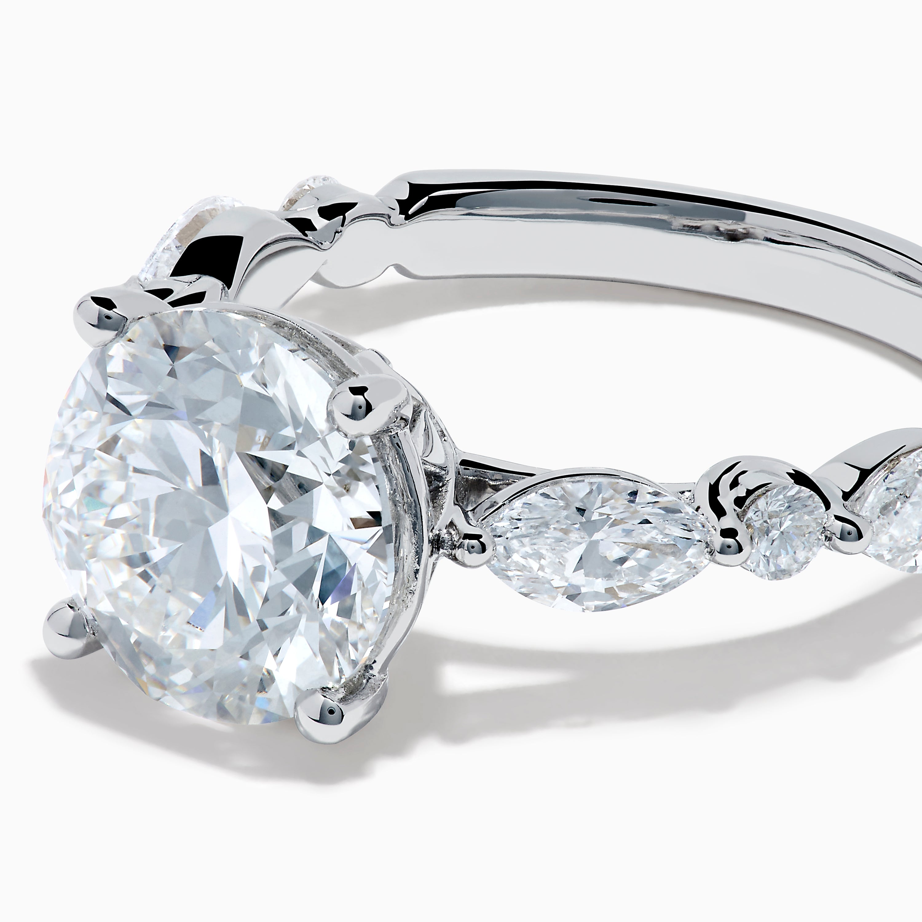 The Star Lab Grown Diamond Ring in 18K White Gold features a large oval lab diamond center with two round diamonds on each side, beautifully set and displayed on a white background.