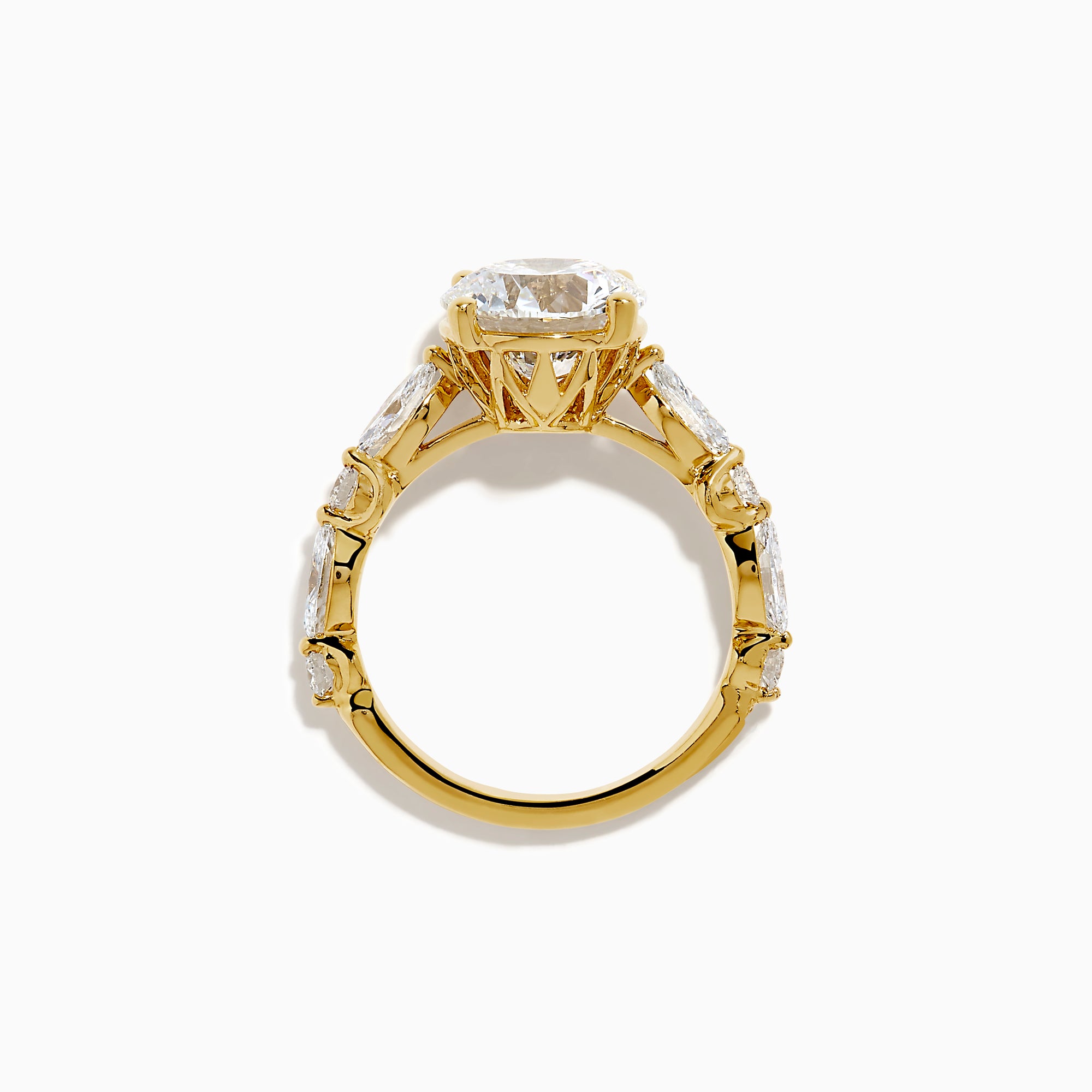 The Star Lab Grown Diamond Ring in 18K Yellow Gold features a large round lab diamond center, accented by three smaller diamonds on each side, all set against a white background.
