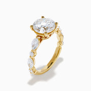 The Star Lab Grown Diamond Ring in 18K Yellow Gold features a large round lab diamond center, accented by three smaller diamonds on each side, all set against a white background.