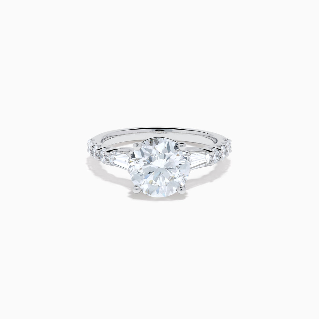 The Star Lab Grown Diamond Ring in 18K White Gold showcases a large oval-cut center stone with baguette and round accents along the band, elegantly presented on a white background.
